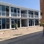 Modern two-story glass facade container office building with meeting rooms and reception area